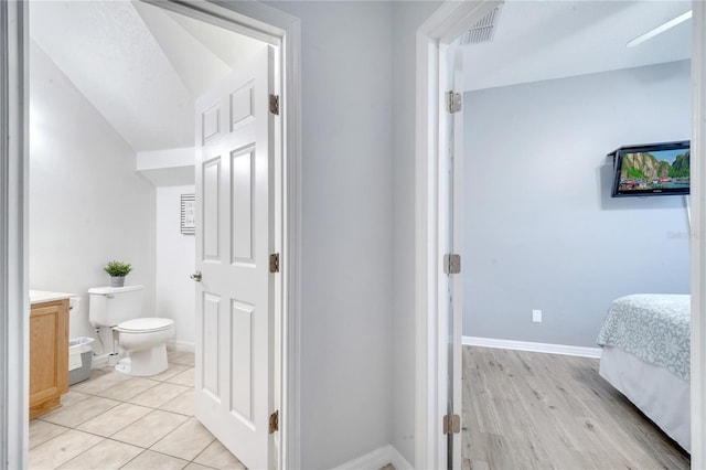 bathroom with toilet, vanity, and hardwood / wood-style flooring