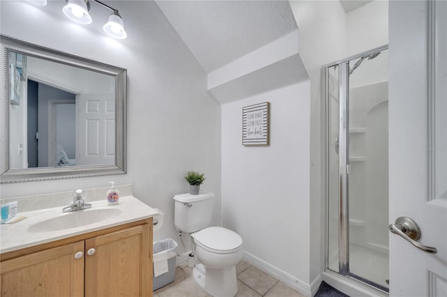 bathroom with vanity, lofted ceiling, tile patterned flooring, toilet, and walk in shower