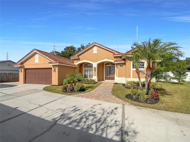 view of front of house featuring a front yard and a garage