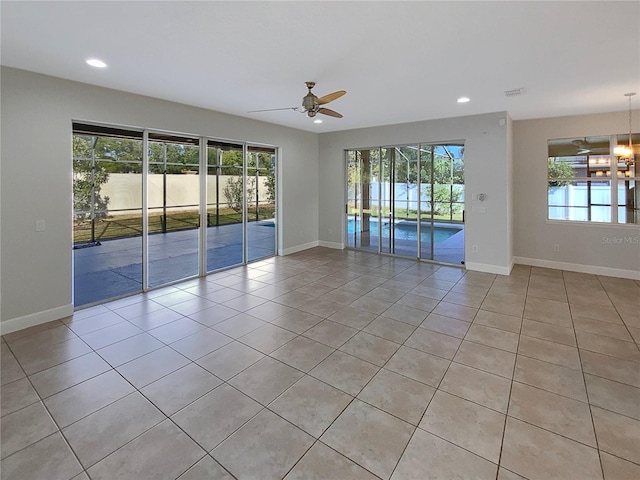 spare room featuring ceiling fan and light tile patterned flooring