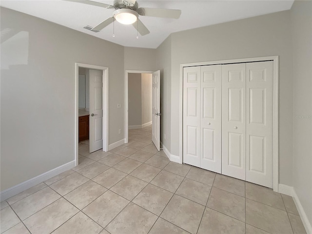 unfurnished bedroom featuring light tile patterned floors, a closet, and ceiling fan