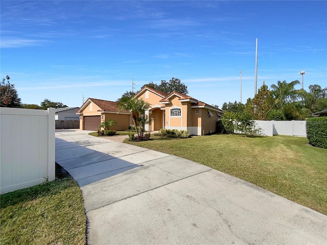 view of front of home featuring a garage and a front lawn