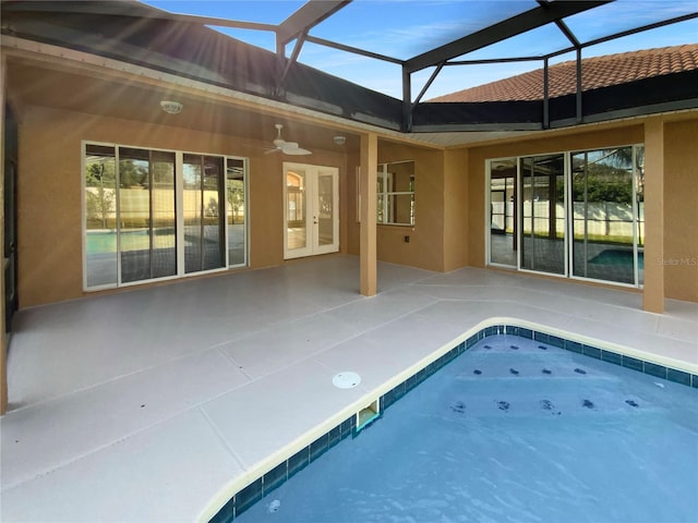 view of pool featuring french doors, a patio, glass enclosure, and ceiling fan