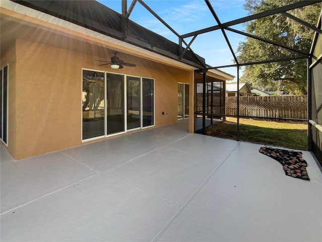 view of patio / terrace with ceiling fan and a lanai