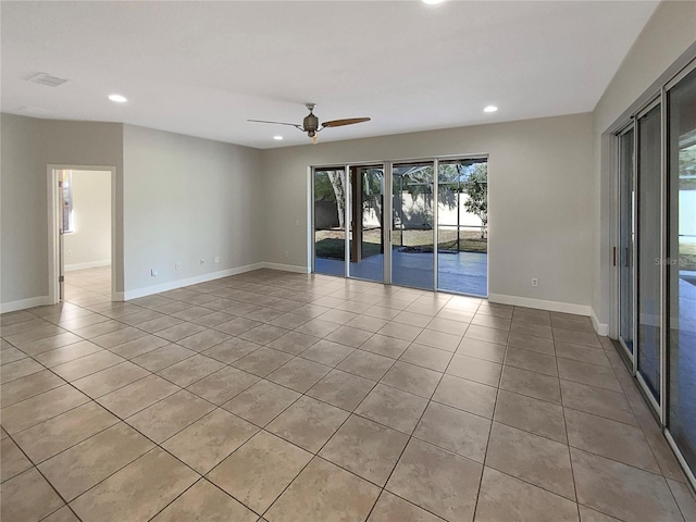 empty room featuring light tile patterned floors and ceiling fan