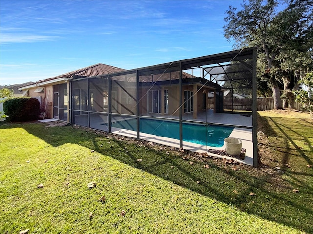 view of swimming pool with a lanai and a yard