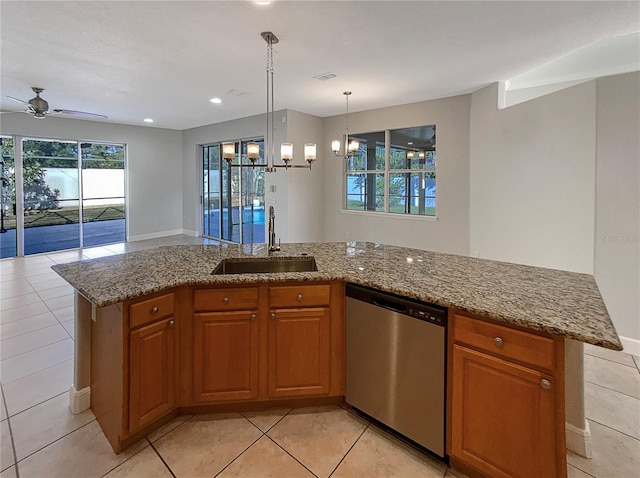 kitchen featuring sink, a center island, stainless steel dishwasher, and ceiling fan with notable chandelier