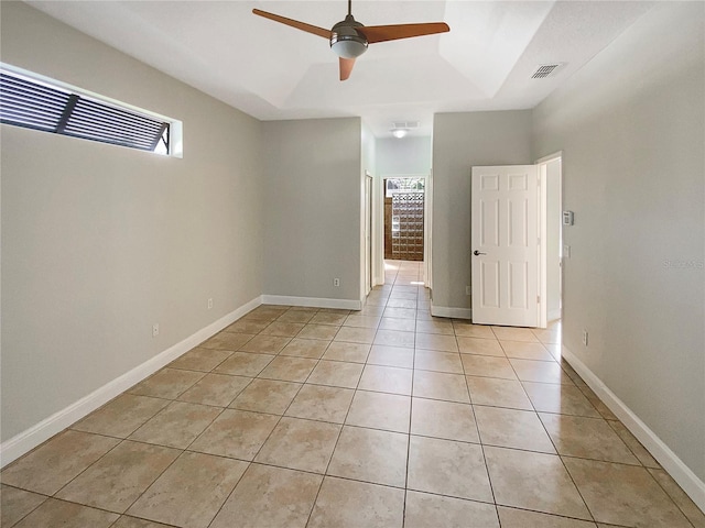 tiled empty room with ceiling fan