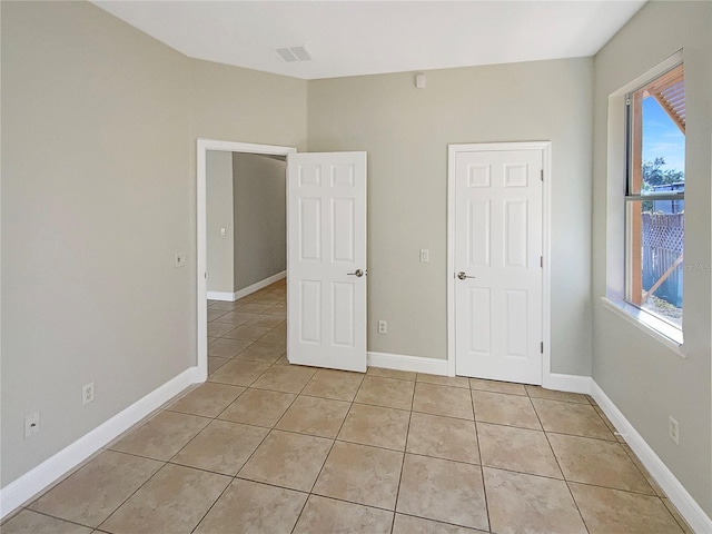 unfurnished bedroom with light tile patterned floors