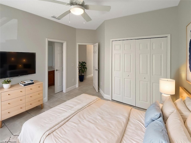 tiled bedroom featuring ceiling fan and a closet