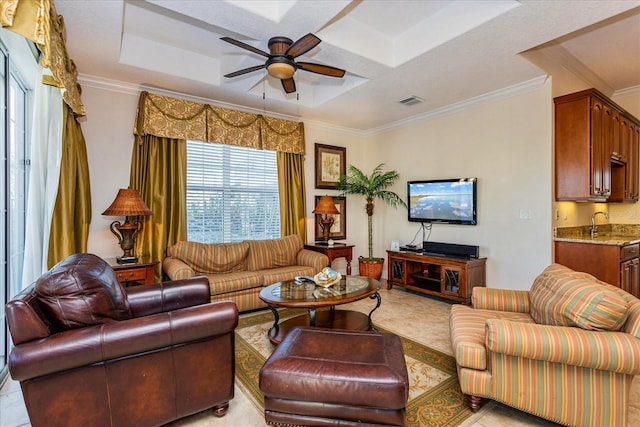 tiled living room featuring a tray ceiling, crown molding, ceiling fan, and a textured ceiling