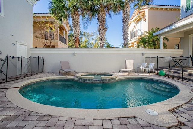 view of swimming pool featuring an in ground hot tub