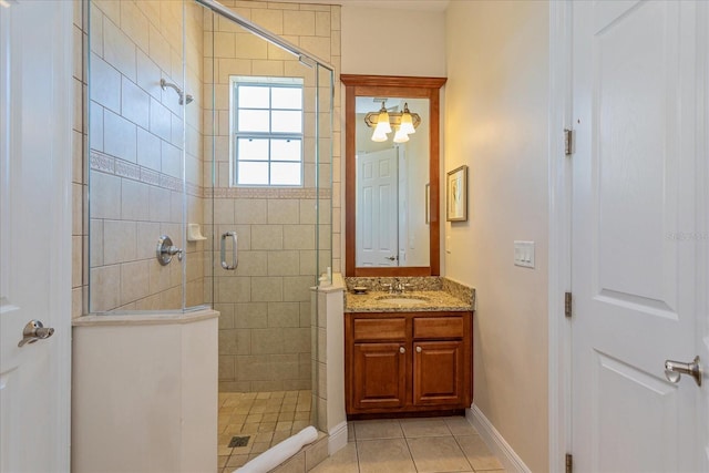 bathroom with tile patterned floors, vanity, and an enclosed shower