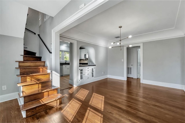 living room with dark hardwood / wood-style floors and a notable chandelier