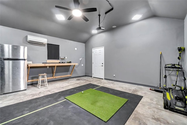 interior space featuring ceiling fan, vaulted ceiling, a wall mounted air conditioner, a workshop area, and concrete flooring