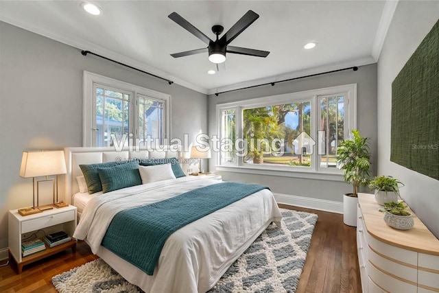 bedroom with ceiling fan, dark hardwood / wood-style flooring, and crown molding