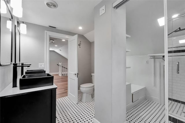 bathroom featuring toilet, lofted ceiling, walk in shower, and vanity