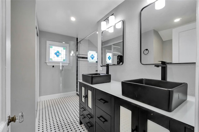 bathroom with vanity, a tile shower, and vaulted ceiling