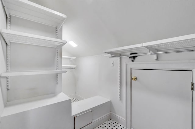 walk in closet featuring lofted ceiling