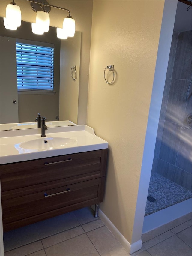 bathroom with a shower, vanity, and tile patterned floors