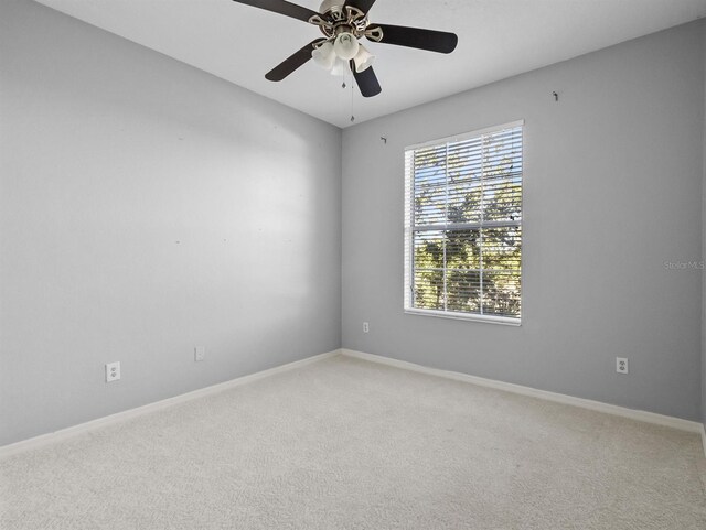 empty room featuring carpet floors and ceiling fan