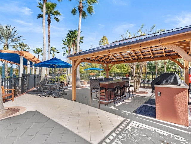 view of patio with a gazebo and an outdoor bar