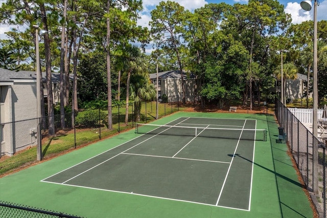 view of tennis court with basketball hoop