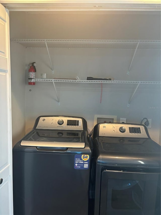 washroom featuring washing machine and dryer