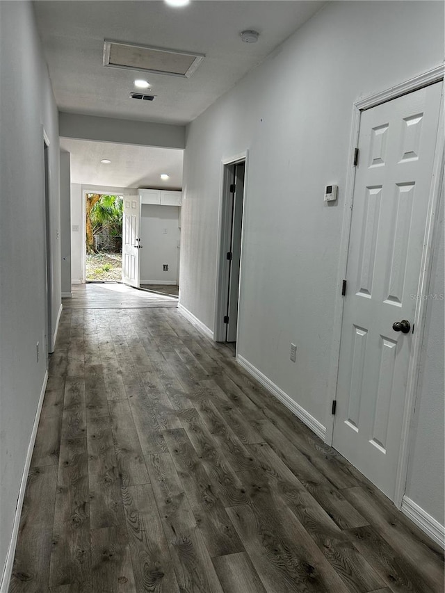 hall with dark hardwood / wood-style flooring