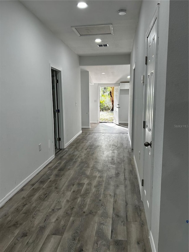 corridor with dark hardwood / wood-style flooring