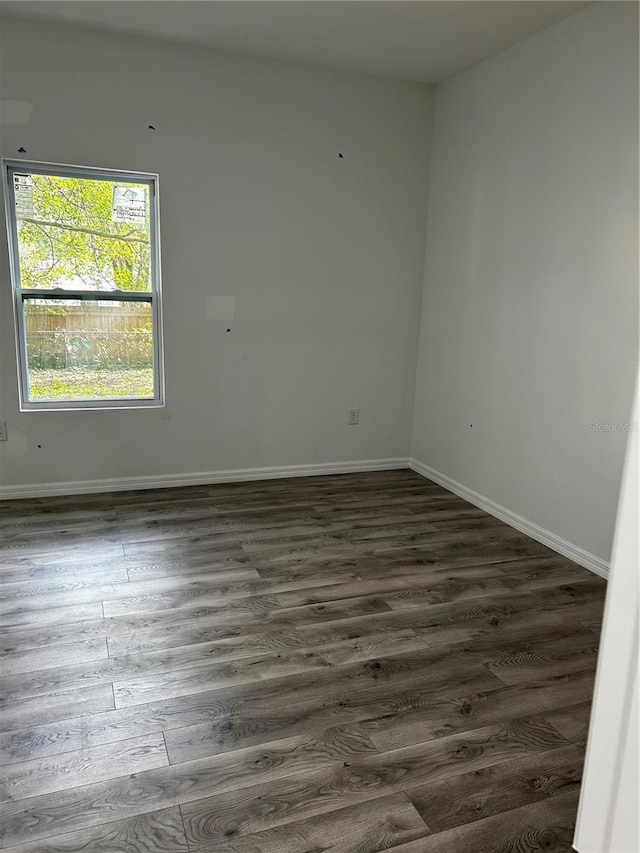 unfurnished room featuring dark wood-type flooring