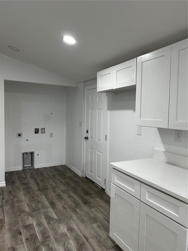 washroom with hookup for a washing machine, cabinets, dark hardwood / wood-style floors, and hookup for an electric dryer