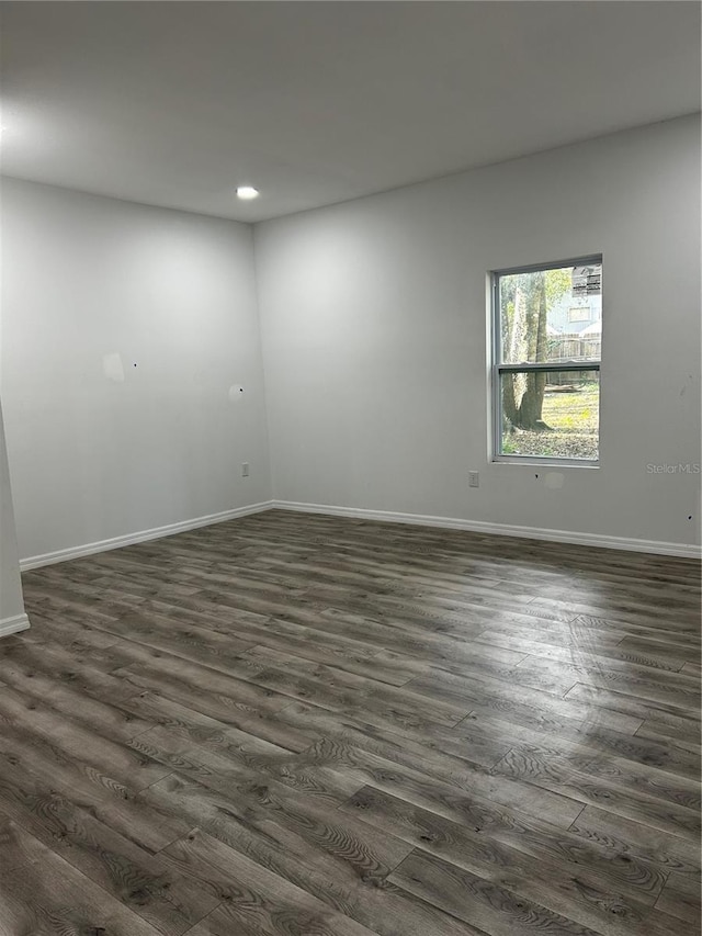 spare room with dark hardwood / wood-style flooring