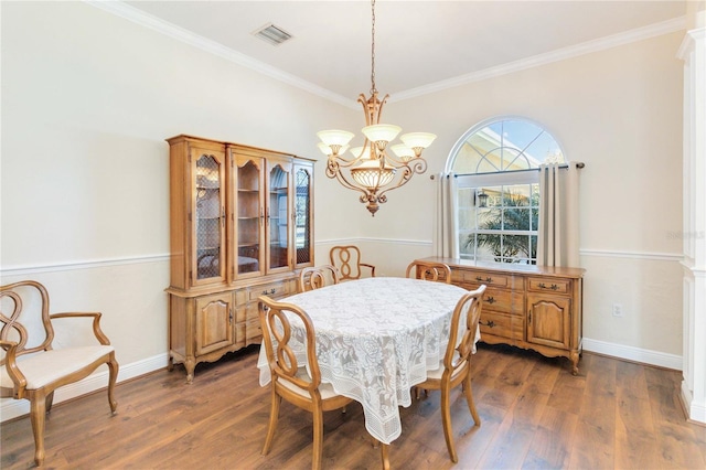 dining space with dark hardwood / wood-style floors and ornamental molding