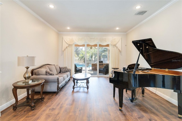 sitting room featuring hardwood / wood-style floors and crown molding