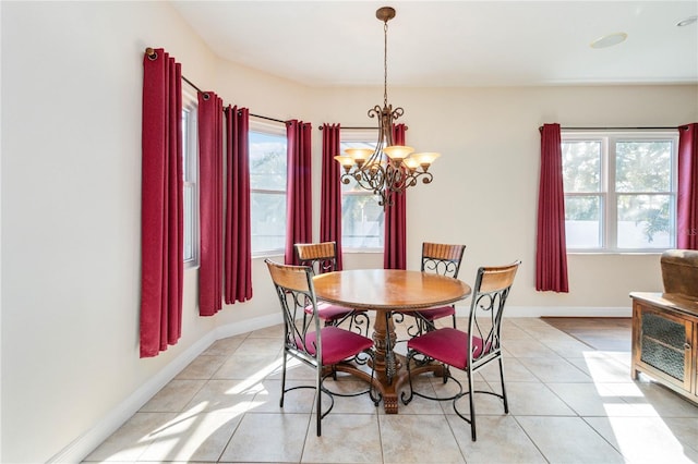 dining area featuring plenty of natural light, light tile patterned floors, and a chandelier