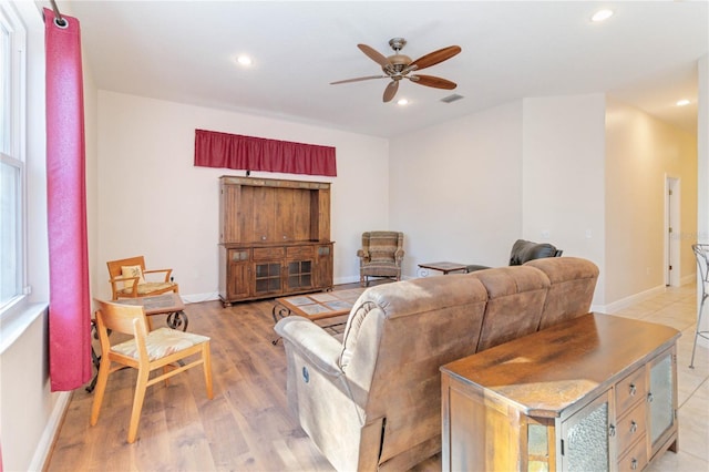 living room with ceiling fan and light hardwood / wood-style floors