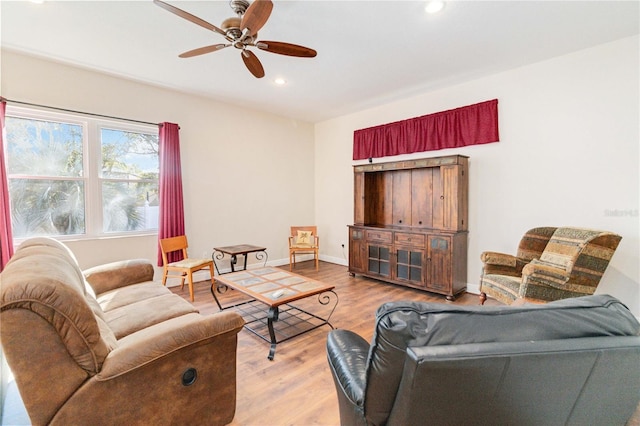 living room with ceiling fan and light wood-type flooring