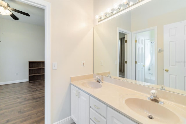 bathroom with ceiling fan, vanity, and wood-type flooring