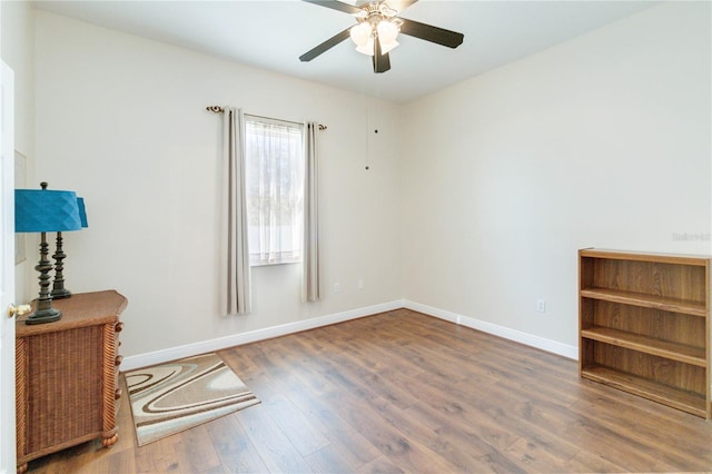 unfurnished room featuring ceiling fan and dark wood-type flooring