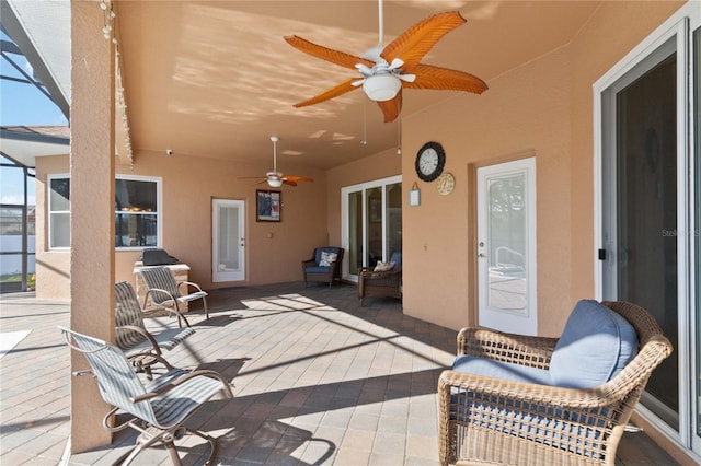 view of patio / terrace featuring ceiling fan and a lanai