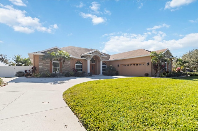 ranch-style home featuring a garage and a front lawn