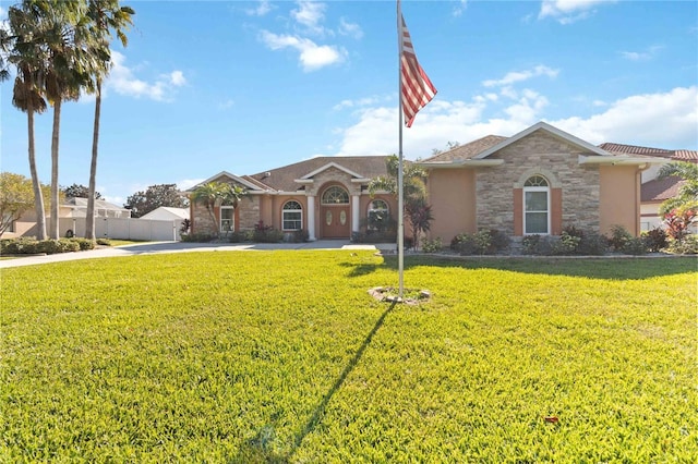 ranch-style house featuring a front lawn