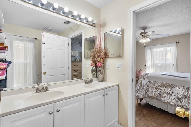 bathroom with vanity, a textured ceiling, tile patterned floors, and ceiling fan