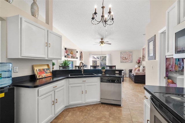 kitchen featuring sink, stainless steel appliances, lofted ceiling, a textured ceiling, and white cabinets