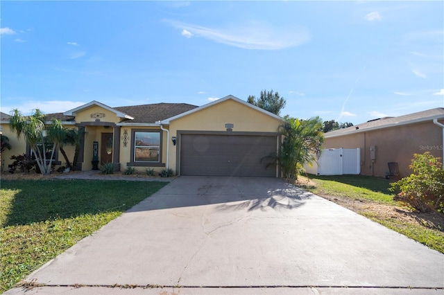 single story home with a garage and a front lawn