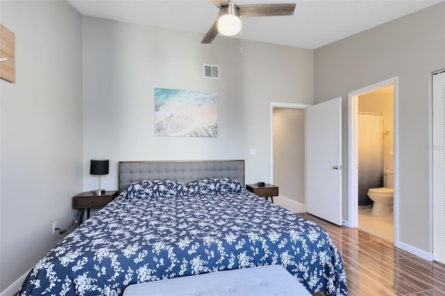 bedroom featuring hardwood / wood-style flooring, ceiling fan, and ensuite bath