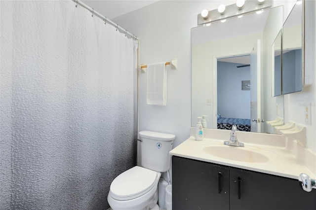 bathroom with a shower with curtain, vanity, and toilet