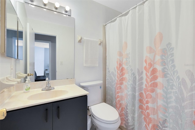 bathroom featuring vanity, a shower with shower curtain, and toilet