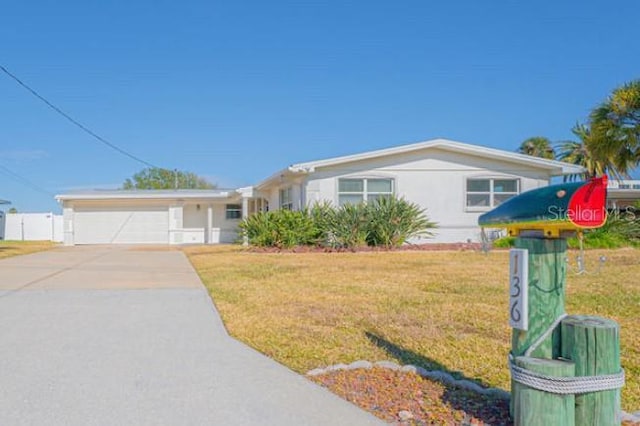 ranch-style house with a front yard and a garage